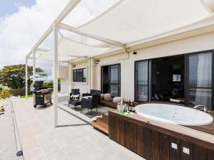 a bathroom with a tub on a patio at Cy MOTOBU - Vacation STAY 98153v in Ufugumui