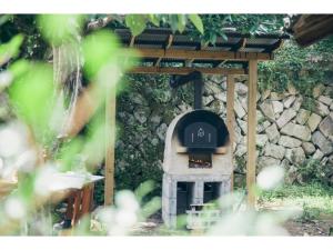 a stone oven in front of a stone wall at Hyogo private house yogoto - Vacation STAY 00235v in Kamikawa
