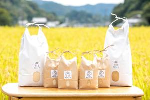 four white bags sitting on a table in front of a field at Nosecho Guest House - Vacation STAY 14366 in Kawabe +6 photos
