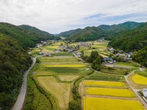 an aerial view of a farm with mountains in the background at Nosecho Guest House - Vacation STAY 14366 in Kawabe