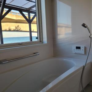 a bath tub in a bathroom with a window at Fluctus - Vacation STAY 16974v in Hitachi +30 photos