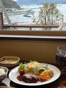 a plate of food on a table next to a window at Populus-club Otaru - Vacation STAY 93434v in Otaru