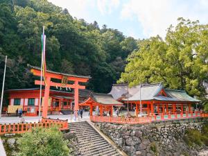 an orange building with stairs in front of a mountain at Kokoyui - Vacation STAY 06794v in Shimosato