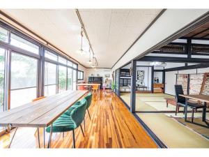 a cafeteria with a large wooden table and chairs at Dan Hiyori - Vacation STAY 08978v in Ebino +14 photos