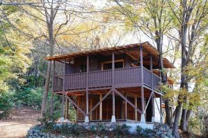 a large wooden house in the middle of trees at Mahora Inahoyama - Vacation STAY 20484v in Minano