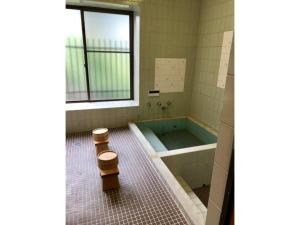 a bathroom with a tub and a toilet in it at Masaya Villa - Vacation STAY 23215v in Ito