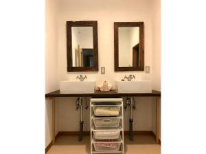 a bathroom with two sinks and two mirrors at Masaya Villa - Vacation STAY 23215v in Ito