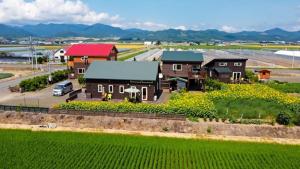 an aerial view of a house with a field of flowers at Country Cottage Waki Aiai - Vacation STAY 26503v in Sorachi