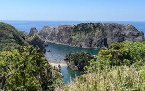 a view of a beach with rocks and the ocean at village yumigahama - Vacation STAY 49340v in Minato +4 photos