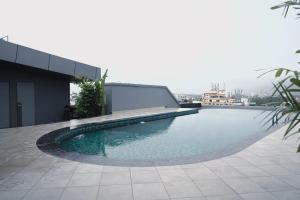 a swimming pool on the roof of a building at Oshin Calicut in Kozhikode