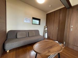 a living room with a couch and a table at On the hill ! ashitoku2 - Vacation STAY 14430 in Akaoki