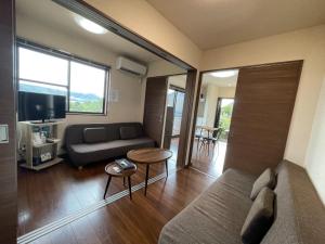 a living room with a couch and a table at On the hill ! ashitoku2 - Vacation STAY 14430 in Akaoki