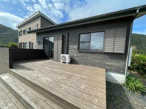 a house with a wooden deck in front of it at On the hill ! ashitoku2 - Vacation STAY 14430 in Akaoki