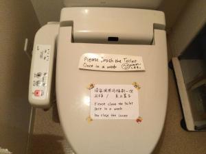 a toilet in a bathroom with a sign on it at ichihara homestay-stay with Japanese family - Vacation STAY 15787 in Ichihara