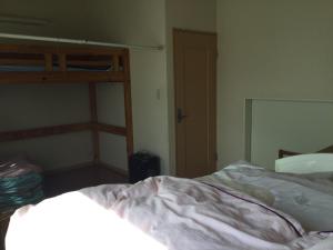 a bedroom with a bed and a bunk bed at ichihara homestay-stay with Japanese family - Vacation STAY 17885 in Ichihara