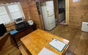 a living room with a table and a refrigerator at village yumigahama - Vacation STAY 29151v in Minato