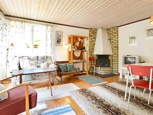 a living room with a couch and a fireplace at 4 person holiday home in Mönsterås-By Traum in Mönsterås