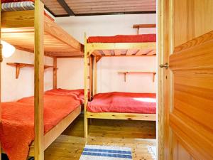 two bunk beds in a room with a door at 4 person holiday home in Mönsterås-By Traum in Mönsterås