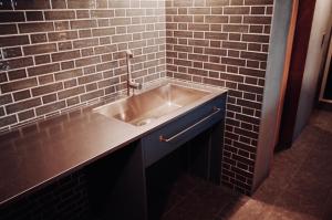 a sink in a bathroom with a brick wall at MAGATAMA,INN - Vacation STAY 41790v in Sumoto +27 photos