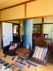 a living room with leather chairs and a table at Tenya - Vacation STAY 34204v in Kami Amakusa