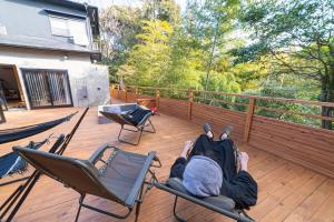 a person laying in chairs on a deck at simanoyadoya - Vacation STAY 39564v in Awaji