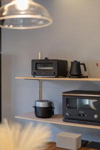 a microwave and a toaster oven on a shelf at simanoyadoya - Vacation STAY 39564v in Awaji