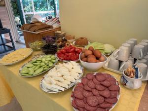 a table with different types of food on plates at Хотел Грация in Lozenets