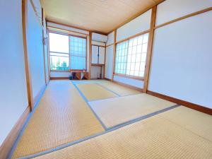 an empty room with windows and mats on the floor at Tateyama Retreat - Vacation STAY 44033v in Tateyama