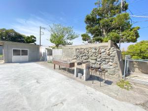a stone building with a bench and a stone wall at Tateyama Retreat - Vacation STAY 44033v in Tateyama
