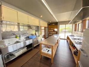 a large kitchen with stainless steel counters and stainless steel appliances at Tateyama Retreat - Vacation STAY 44033v in Tateyama