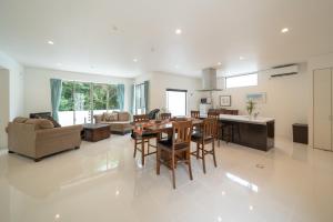 a kitchen and living room with a table and chairs at kukulu island - Vacation STAY 37864v in Kouri