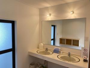a bathroom with two sinks and a large mirror at Tateyama Retreat - Vacation STAY 44033v in Tateyama +9 photos