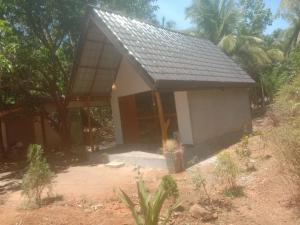 a small house with a gray roof at Rangiri Villa Sigiriya in Dambulla