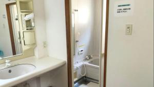 a bathroom with a sink and a toilet and a tub at Tabino Camping Base Kami Yuland - Vacation STAY 52575v in Osaki