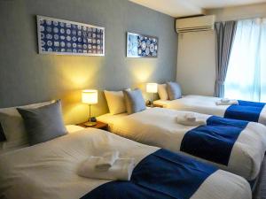 Postel nebo postele na pokoji v ubytování &haku Kyoto Marutamachi