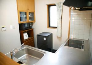 a small kitchen with a sink and a refrigerator at Farm Inn Neba - Vacation STAY 42194v in Urugi