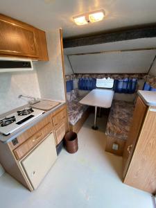 a small kitchen with a stove and a table at NAT PARK - Camp - Vacation STAY 42069v in Iwada