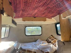 a bedroom in an rv with a bed and a window at NAT PARK - Camp - Vacation STAY 42069v in Iwada