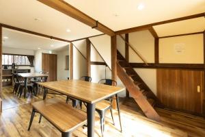 a dining room with wooden tables and chairs at The minpark - Vacation STAY 14641 in Dazaifu