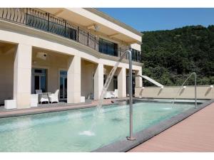 a swimming pool in front of a house at Atami Spa & Resort - Vacation STAY 14644 in Atami