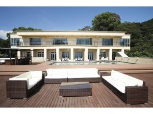 a large building with white furniture in front of it at Atami Spa & Resort - Vacation STAY 14644 in Atami