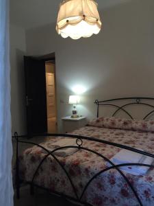 a bedroom with a bed and a chandelier at Casale Del Borgo in Hermada