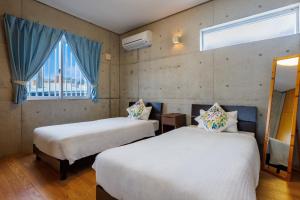 two beds in a room with a window at New Life Mansion 101 - Vacation STAY 57160v in Fuzuchi