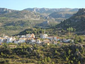 a small town on a hill in the mountains at Pensión El Pirineo in Confrides