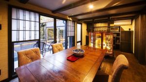 a dining room with a wooden table and chairs at Sumiya Hagakure - Vacation STAY 57892v in Takayama