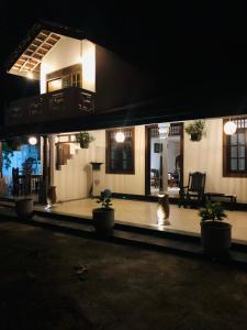 a house at night with potted plants in front of it at Coco Breeze Villa in Talpe +36 photos