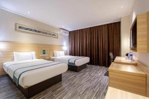 Postel nebo postele na pokoji v ubytování City Comfort Inn Beihai RT-Mart High Speed Railway Station + 209 fotografií