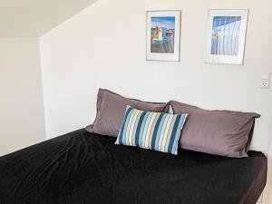 a bed with two pillows on top of it at 5 star holiday home in Hadsund in Øster Hurup