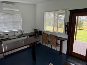 a kitchen with a counter and a table and chairs at Golf Links Sunset Cabin  +2 photos