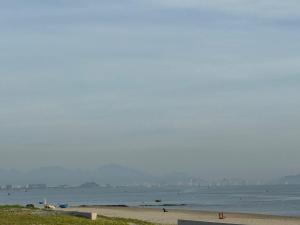 a view of a beach with a city in the distance at Palm Riverside Boutique in Hoi An